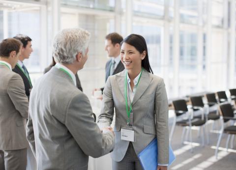 Asian woman greeting white old man