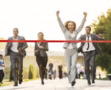 Businesspeople crossing finish line
